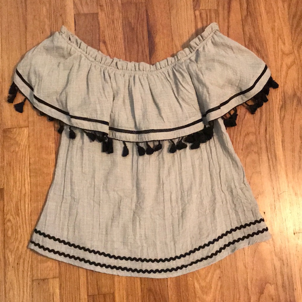 An off the shoulder brown and black shirt